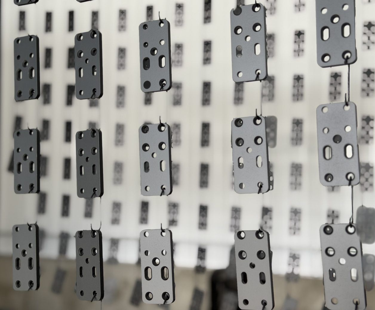 Powder coating in Utah: powder coated hardware brackets on the hang line at Proper Powder Coating near Ogden